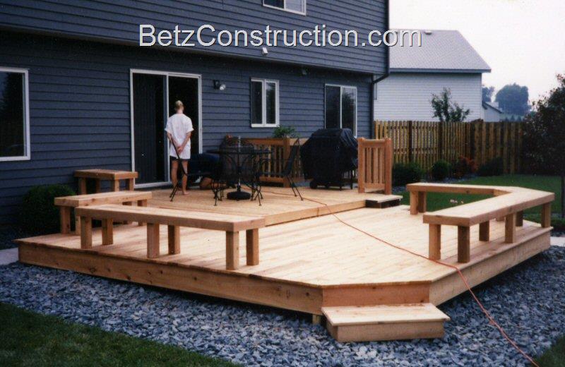 Cedar Multi-level patio deck with paving stones at ground level and 